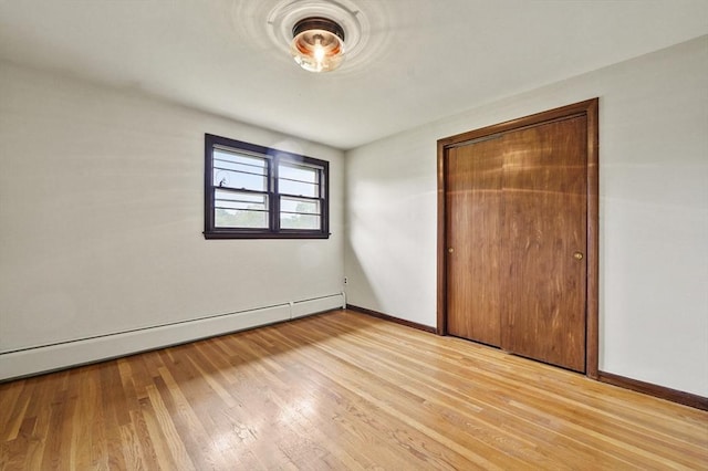 466 Hosmer St, Marlborough, MA 01752 - unfurnished bedroom featuring a baseboard heating unit, light wood finished floors, and a closet