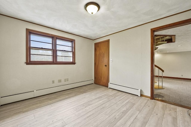 466 Hosmer St, Marlborough, MA 01752 - unfurnished room featuring a baseboard radiator, crown molding, stairway, and wood finished floors