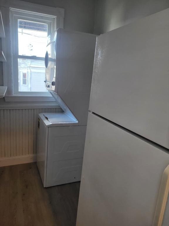 8 Dawes St, Boston, MA 02125 - washroom with wood finished floors and stacked washer / dryer