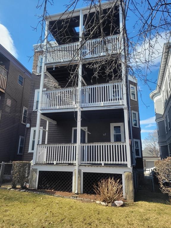 8 Dawes St, Boston, MA 02125 - view of front facade featuring a balcony and a gate