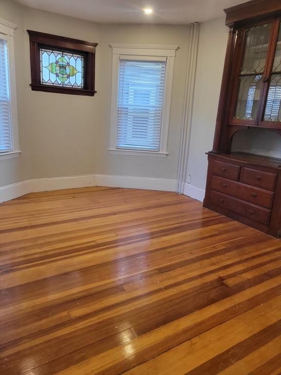 8 Dawes St, Boston, MA 02125 - empty room featuring wood finished floors and baseboards