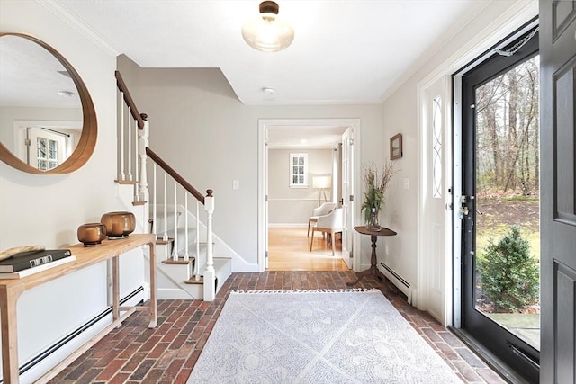 foyer entrance with brick floor, stairway, a baseboard radiator, and baseboards