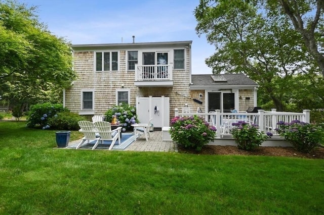 back of house featuring a yard, a patio area, and a wooden deck