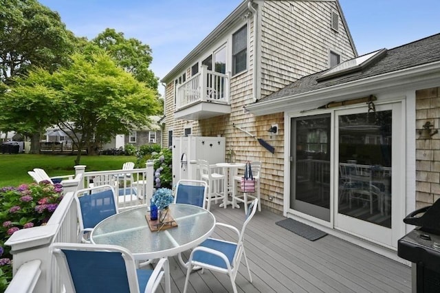 wooden terrace featuring outdoor dining area