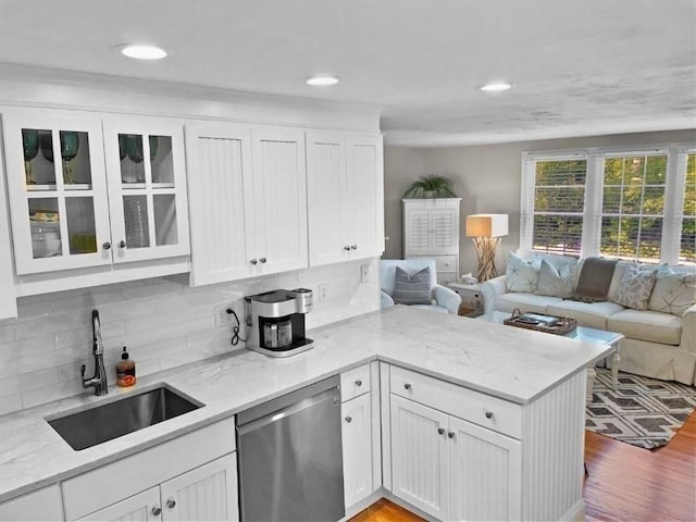 kitchen with dishwasher, open floor plan, glass insert cabinets, and white cabinetry