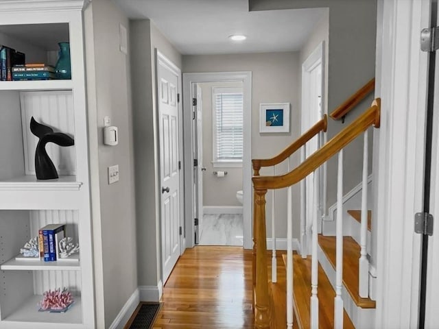 entrance foyer featuring stairs, light wood-style flooring, and baseboards