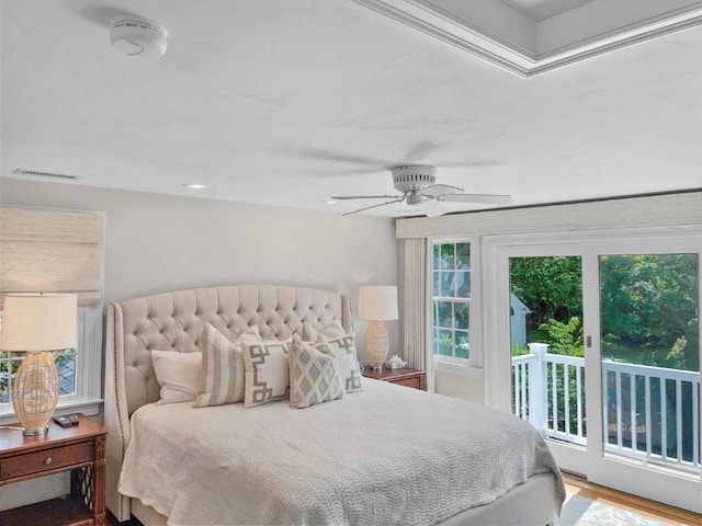 bedroom with access to exterior, ceiling fan, visible vents, and wood finished floors