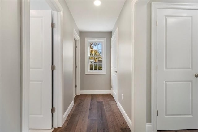 hall featuring dark wood finished floors and baseboards