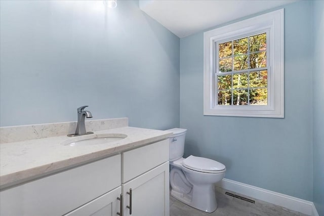 bathroom with toilet, baseboards, visible vents, and vanity