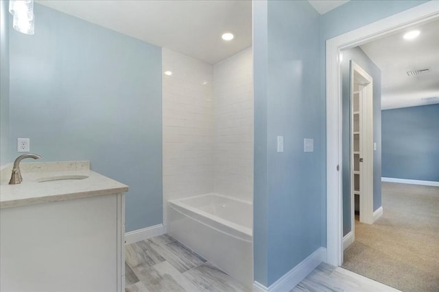 bathroom featuring recessed lighting, vanity, visible vents, baseboards, and tub / shower combination