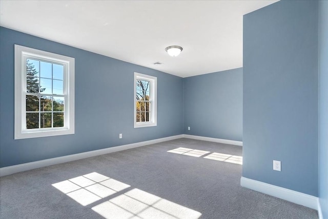 carpeted empty room with baseboards