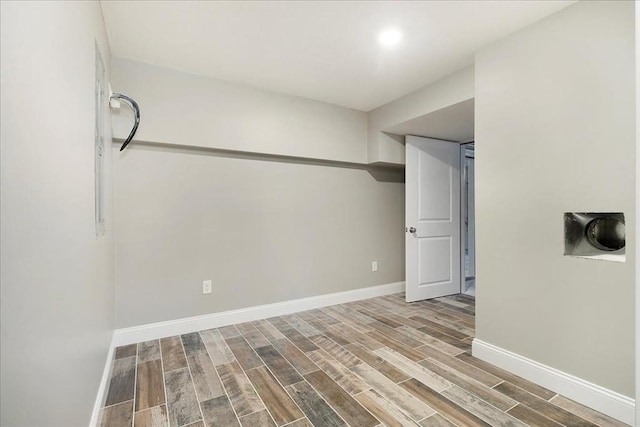 empty room with wood tiled floor and baseboards