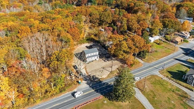 bird's eye view with a wooded view