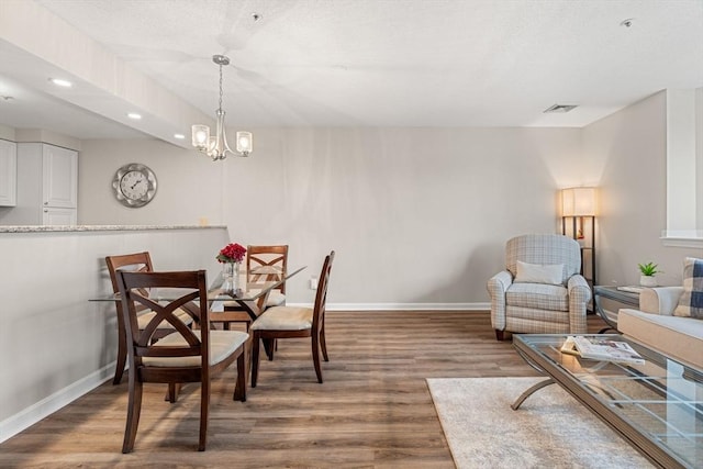 dining room with recessed lighting, visible vents, baseboards, and wood finished floors