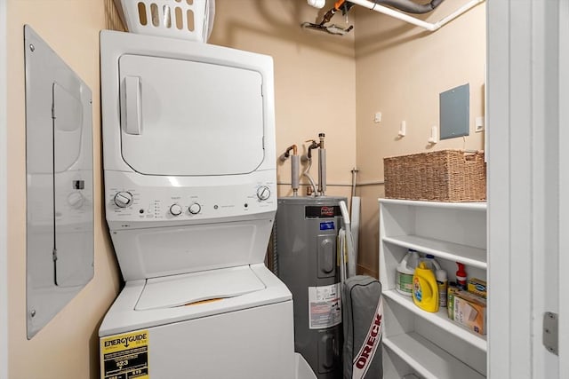 laundry area featuring laundry area, electric water heater, and stacked washer and dryer