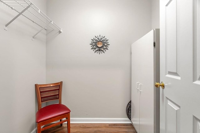 interior space with baseboards and wood finished floors