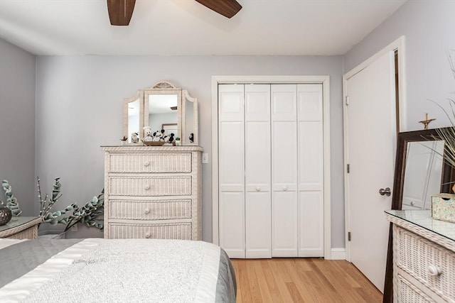 bedroom with a closet, light wood-style flooring, and ceiling fan