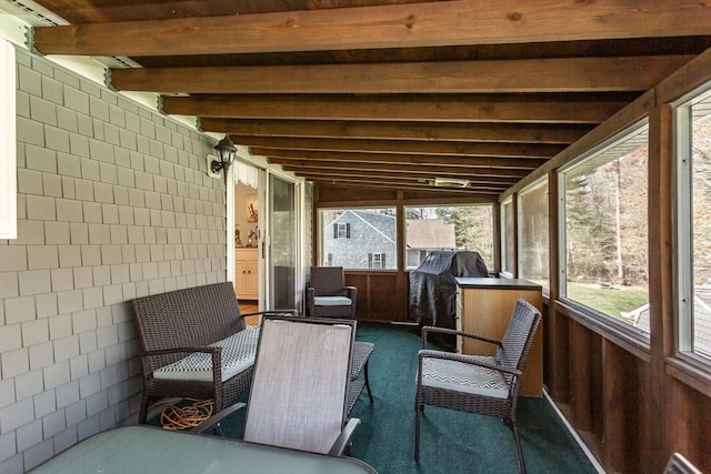 sunroom with beamed ceiling