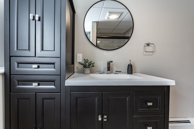 bathroom with baseboard heating and vanity