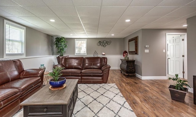 living room featuring baseboards, recessed lighting, and wood finished floors