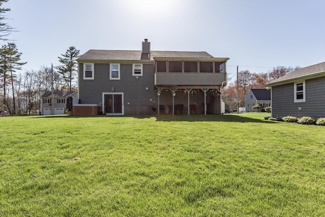 rear view of property with a sunroom, a lawn, and a chimney
