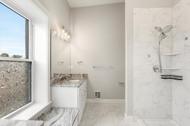 28 Main St Unit 4, Medford, MA 02155 - full bath with marble look tiles, vanity, a tile shower, and baseboards