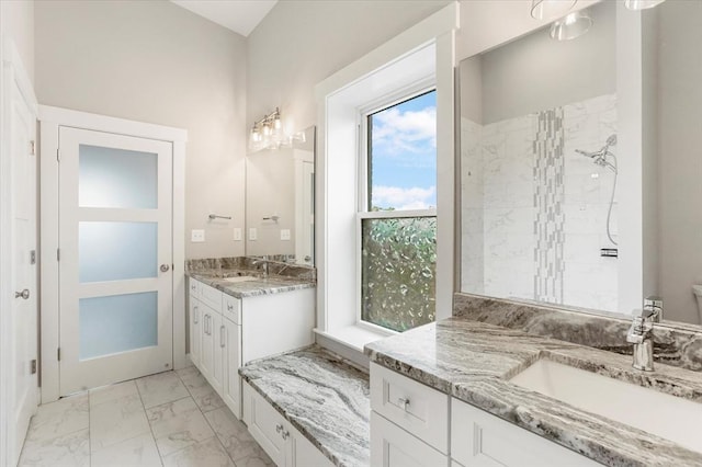28 Main St Unit 4, Medford, MA 02155 - full bath featuring marble look tiles, two vanities, and tiled shower