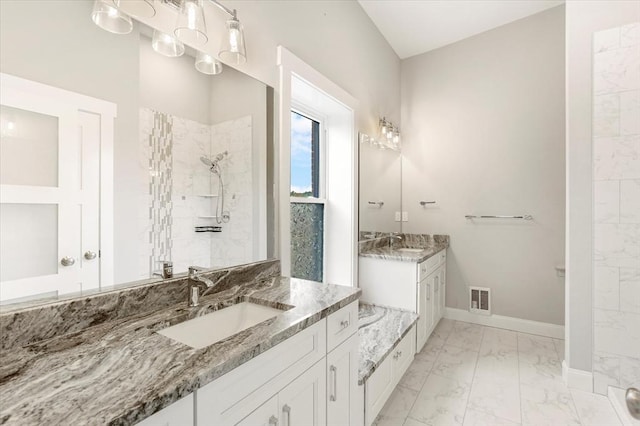 28 Main St Unit 4, Medford, MA 02155 - bathroom with marble finish floors, two vanities, baseboards, and a walk in shower