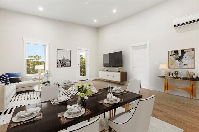 28 Main St Unit 4, Medford, MA 02155 - living room featuring an AC wall unit, light wood-style flooring, recessed lighting, and a towering ceiling