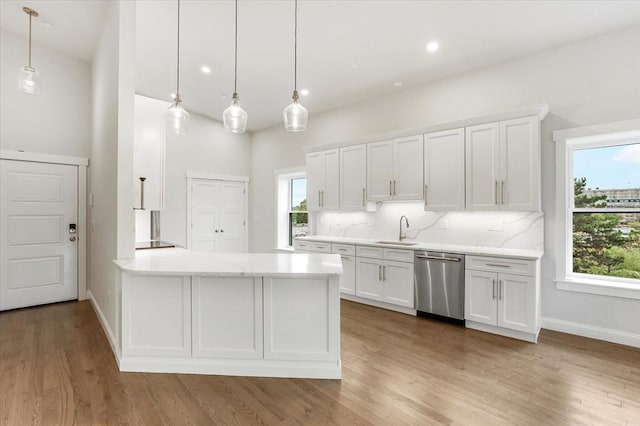 28 Main St Unit 4, Medford, MA 02155 - kitchen with stainless steel dishwasher, a sink, healthy amount of natural light, white cabinetry, and recessed lighting