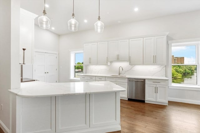 28 Main St Unit 4, Medford, MA 02155 - kitchen featuring stainless steel dishwasher, a sink, white cabinets, tasteful backsplash, and recessed lighting