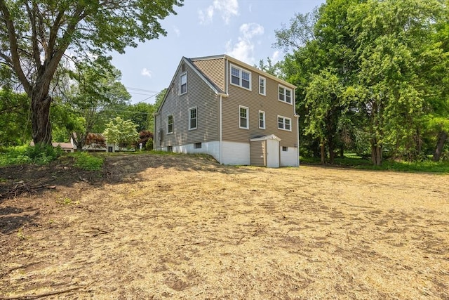 136 E St, South Hadley, MA 01075 - view of side of property featuring an attached garage and a storage unit
