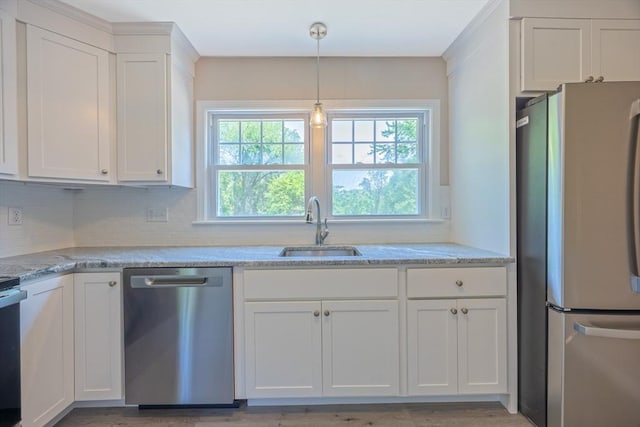 136 E St, South Hadley, MA 01075 - kitchen with appliances with stainless steel finishes, white cabinetry, decorative backsplash, decorative light fixtures, and light stone countertops