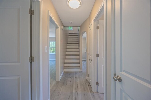 136 E St, South Hadley, MA 01075 - hallway with light wood-style floors, stairs, and arched walkways