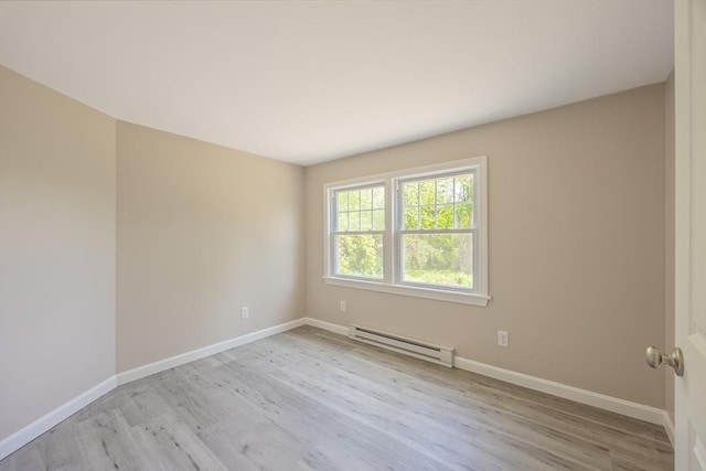 136 E St, South Hadley, MA 01075 - empty room with a baseboard heating unit and wood finished floors