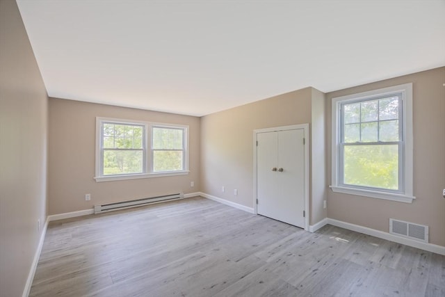 136 E St, South Hadley, MA 01075 - unfurnished room featuring a baseboard heating unit and light wood-style flooring