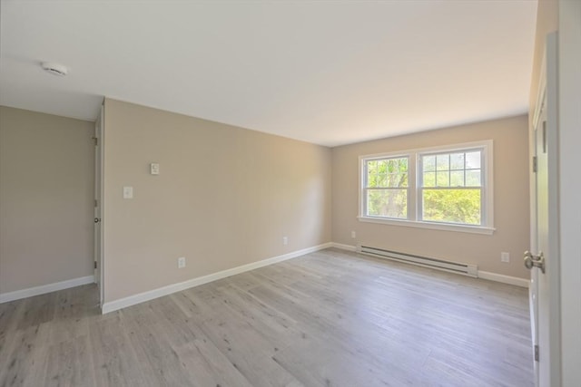 136 E St, South Hadley, MA 01075 - empty room with a baseboard radiator, a smoke detector, and light wood-style floors
