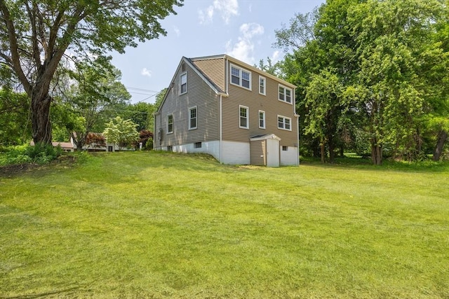 136 E St, South Hadley, MA 01075 - view of side of home with an attached garage, a shed, and a lawn