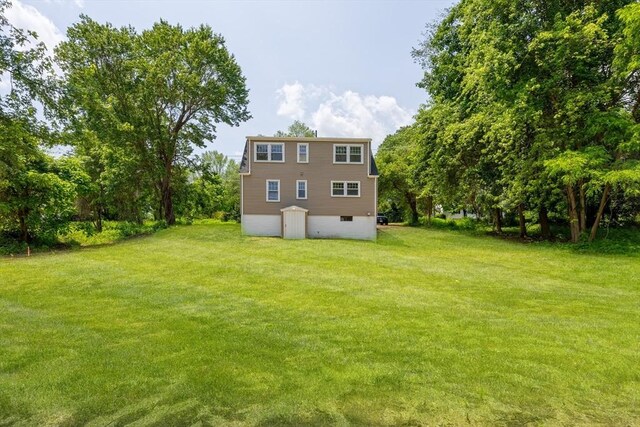 136 E St, South Hadley, MA 01075 - back of house featuring a yard and a garage