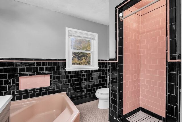 full bathroom featuring separate shower and tub, toilet, tile walls, vanity, and tile patterned flooring