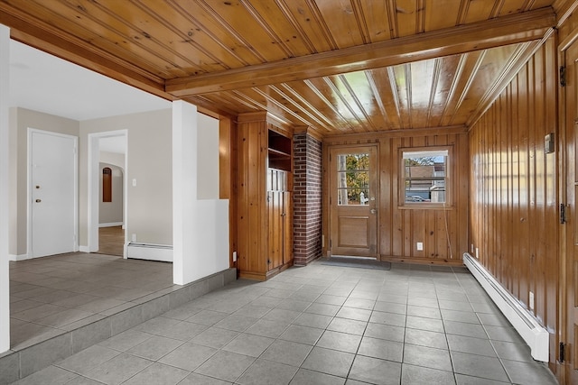 unfurnished room with wooden ceiling and a baseboard heating unit