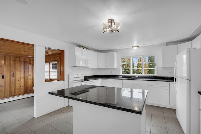 kitchen featuring white cabinets, sink, a kitchen island, and white appliances