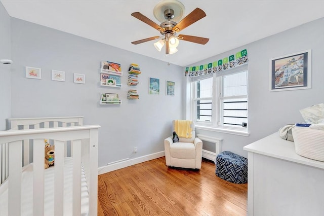 9 Twomey Ct Unit 52, Boston, MA 02127 - bedroom featuring wood finished floors, a ceiling fan, and a nursery area