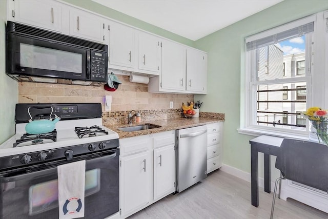 9 Twomey Ct Unit 52, Boston, MA 02127 - kitchen with white gas range, black microwave, dishwasher, and white cabinets