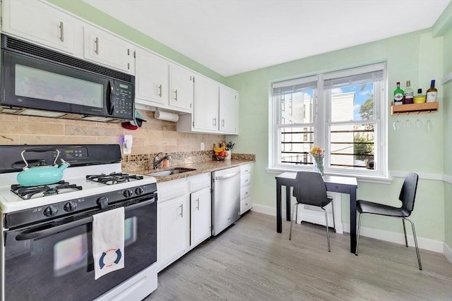 9 Twomey Ct Unit 52, Boston, MA 02127 - kitchen featuring gas stove, stainless steel dishwasher, black microwave, white cabinetry, and backsplash