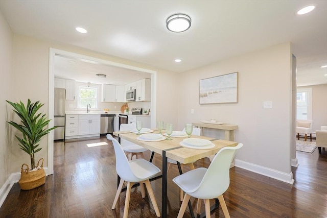 dining room with baseboards, dark wood-style floors, and recessed lighting
