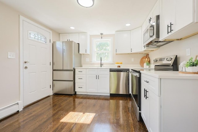 kitchen featuring appliances with stainless steel finishes, a baseboard radiator, dark wood-style floors, light countertops, and white cabinetry