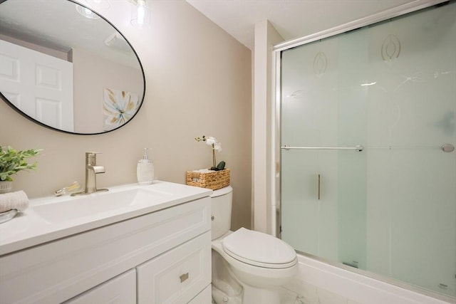 full bath with a shower stall, toilet, vanity, and marble look tiles