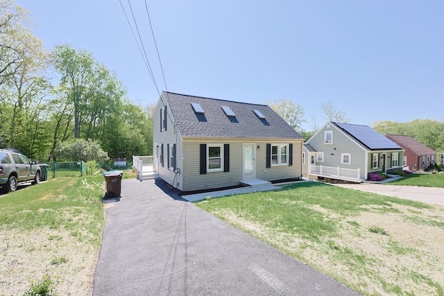 view of front of property with driveway and a shingled roof