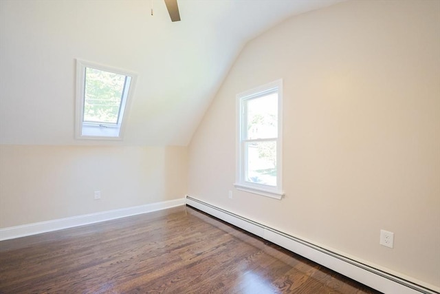 bonus room featuring a baseboard heating unit, vaulted ceiling, dark wood-style flooring, ceiling fan, and baseboards